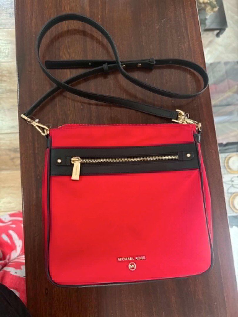 Michael Kors Red Nylon Crossbody Bag (Category: Cross-body Bags) located in Manila. Submitted by kobealvarez (Listing ID 1441481566, Image 1). Description: - Red Michael Kors crossbody bag - Black trim and gold hardware - Zip closure on front pocket and main compartment - Adjustable strap - Interior zip pocket and card slots - Ideal for everyday use - with tag 108$.
