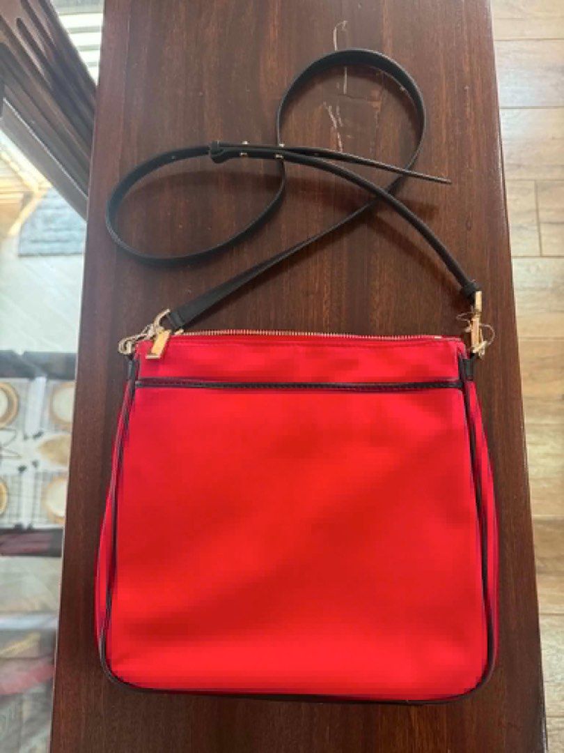 Michael Kors Red Nylon Crossbody Bag (Category: Cross-body Bags) located in Manila. Submitted by kobealvarez (Listing ID 1441481566, Image 2). Description: - Red Michael Kors crossbody bag - Black trim and gold hardware - Zip closure on front pocket and main compartment - Adjustable strap - Interior zip pocket and card slots - Ideal for everyday use - with tag 108$.