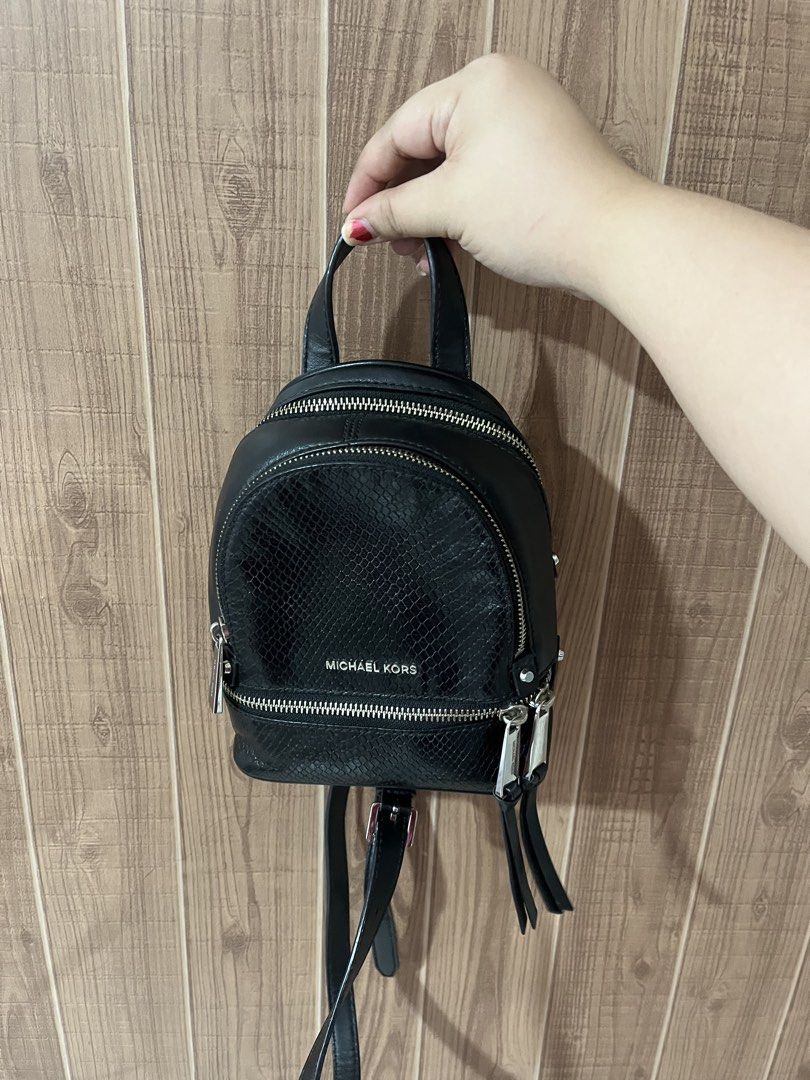 Michael Kors Mini Rhea Backpack Genuine Leather (Retail) (Category: Backpacks) located in Quezon City. Submitted by myyyfinds (Listing ID 1441396174, Image 1). Description: Genuine Leather with Snakeskin Design comes with 2 straps for backpack can be converted to crossbody (like LV PALM SPRINGS) Guaranteed authentic with cards and original satin dustbag. Bought from MK Retail Store (not outlet) VERY GOOD CONDITION, SILVER METALS VERY SHINY NO TO 