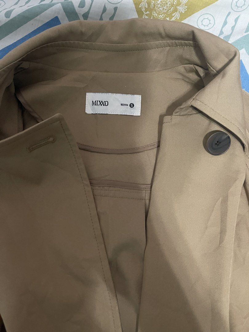 MIXKO Double Breasted Beige Trench Coat Size S (Category: Coats, Jackets and Outerwear) located in Manila. Submitted by fiercestone-4d17 (Listing ID 1441470095, Image 3). Description: - Beige trench coat from MIXKO - Double-breasted style with a belt - Features pockets and button closure - Size S - Ideal for layering over any outfit - Versatile for casual or smart casual looks.