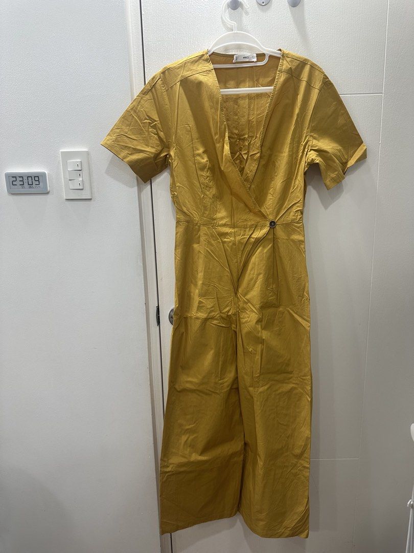 MNG Mustard Yellow Wrap Jumpsuit Size M (Category: Jumpsuits) located in Quezon City. Submitted by _cc_declutters (Listing ID 1441390503, Image 1). Description: - Cute mustard yellow jumpsuit from MNG - Features a stylish wrap front with side button detail - Comfortable short sleeves and a trendy wide leg - Elasticated back waist for a perfect fit - Versatile for casual outings or dressing up.
