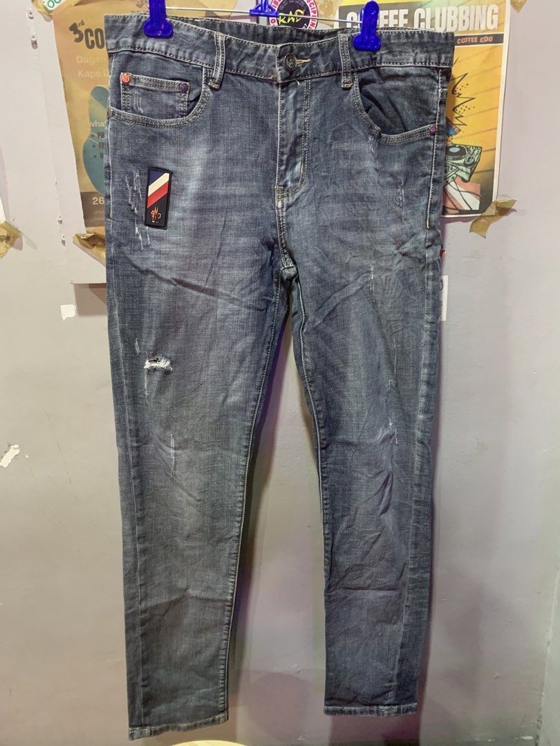 Moncler Grey Distressed Denim Jeans (Category: Luxury Apparel) located in Cagayan de Oro. Submitted by agboysalis60090 (Listing ID 1441563369, Image 1). Description: Grey Moncler jeans. Distressed detailing on the front and back. Button fly with YKK zipper. Patch detail on the left thigh. Red accent on the right leg. Made from denim. Machine washable..