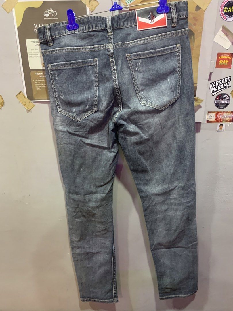 Moncler Grey Distressed Denim Jeans (Category: Luxury Apparel) located in Cagayan de Oro. Submitted by agboysalis60090 (Listing ID 1441563369, Image 2). Description: Grey Moncler jeans. Distressed detailing on the front and back. Button fly with YKK zipper. Patch detail on the left thigh. Red accent on the right leg. Made from denim. Machine washable..