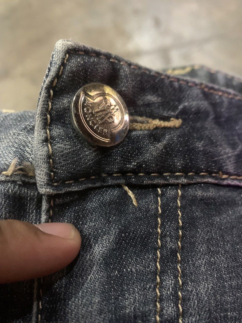 Moncler Grey Distressed Denim Jeans (Category: Luxury Apparel) located in Cagayan de Oro. Submitted by agboysalis60090 (Listing ID 1441563369, Image 3). Description: Grey Moncler jeans. Distressed detailing on the front and back. Button fly with YKK zipper. Patch detail on the left thigh. Red accent on the right leg. Made from denim. Machine washable..