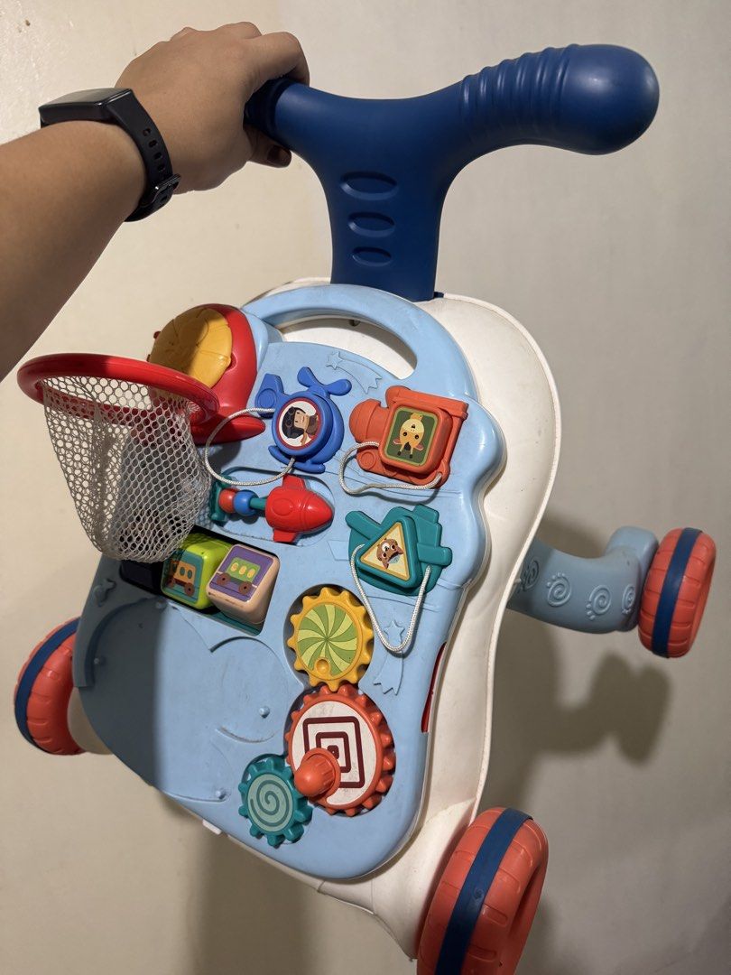 Musical Stroller & Table 2-in-1 Educational Baby Walker (Category: Infant Playtime) located in Pasig City. Submitted by rodzrox (Listing ID 1441509398, Image 2). Description: - 2-in-1 Musical Stroller and Educational Table - Includes Basketball Hoop with Balls - Features various Interactive Toys and Gears - Suitable for Babies 12 Months and Up - Ideal for Learning and Playtime.