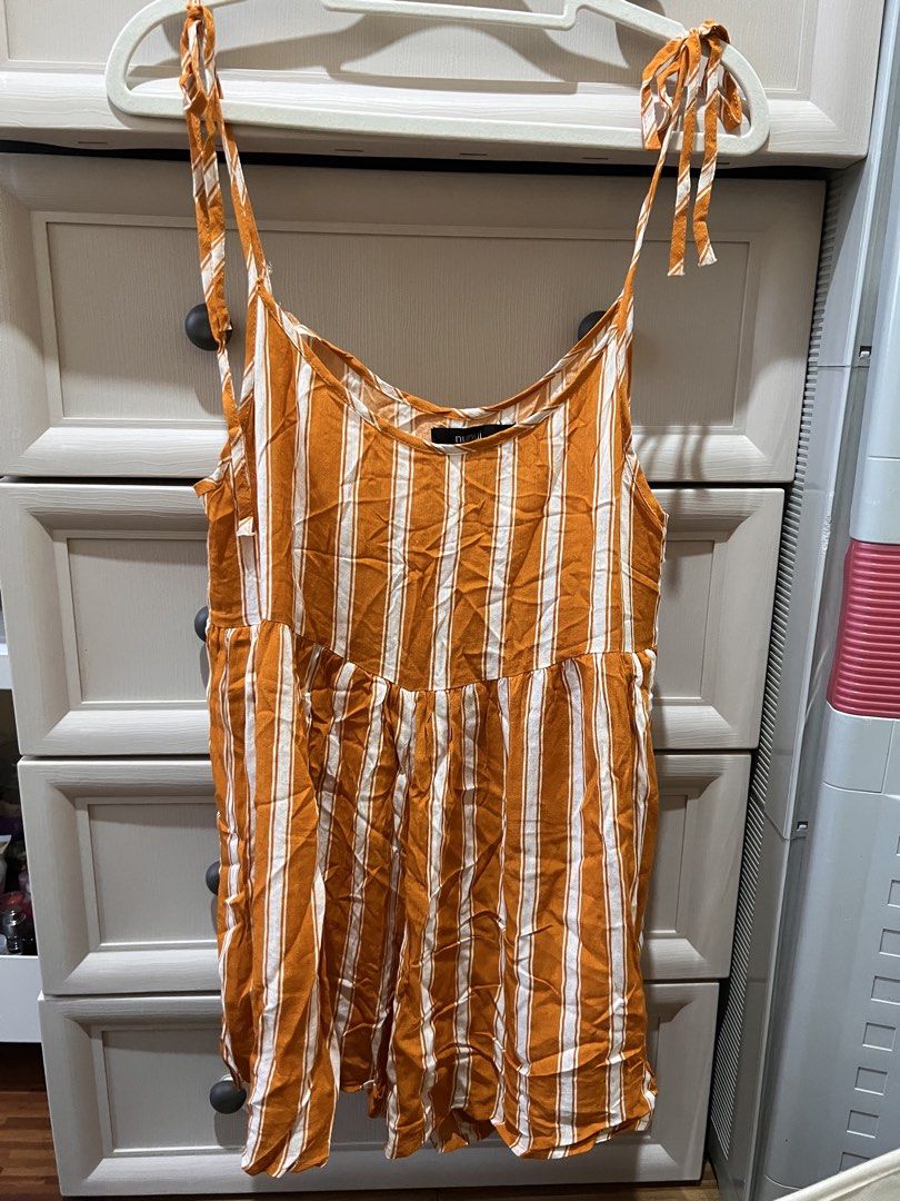(Nunui) Orange White Striped Tie Shoulder Romper (Category: Rompers) located in Angono. Submitted by elyenitty_ (Listing ID 1441516803, Image 1). Description: WITH DAMAGE DUE TO STORAGE IN AU BOX - Nunui orange and white striped romper - Tie shoulder straps - Note: Fraying and damage on straps near neckline (please check photos) - Lightweight fabric, perfect for warm weather - Elasticated waist for a comfortable fit.