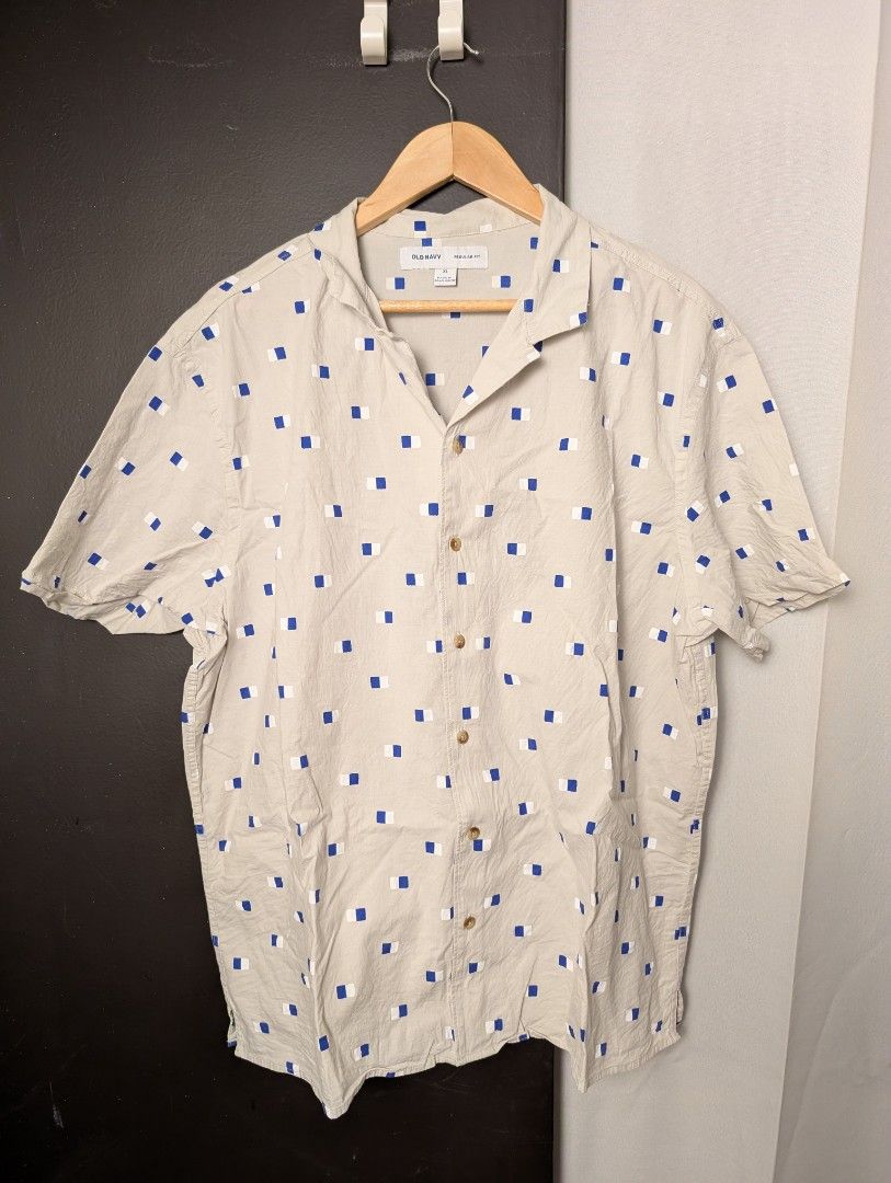 Old Navy Regular Fit Short Sleeve Button Up Shirt (Category: Tshirts & Polo Shirts ) located in Manila. Submitted by miloilmo (Listing ID 1441478755, Image 1). Description: - Old Navy Short Sleeve Shirt - Size: XL - Fit: Regular - Color: Beige - Pattern: Blue and White Geometric - Closure: Button-up front - Style: Casual wear - Used three times only.