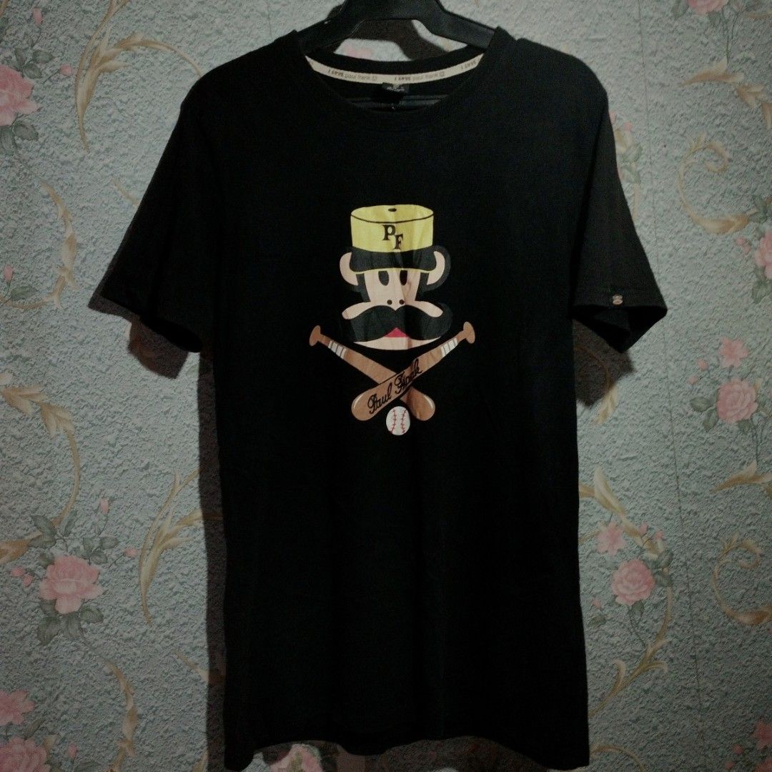 Paul Frank T-shirt with Monkey Graphic (Category: Tshirts & Polo Shirts ) located in Quezon City. Submitted by naotosan1121 (Listing ID 1441473060, Image 1). Description: - Black t-shirt with a cool Paul Frank graphic - Features the iconic monkey character - Monkey is wearing a hat and mustache - Graphic includes crossed baseball bats and a ball - Made of comfortable fabric - Perfect for casual wear Negotiable and for more information just pm!!.
