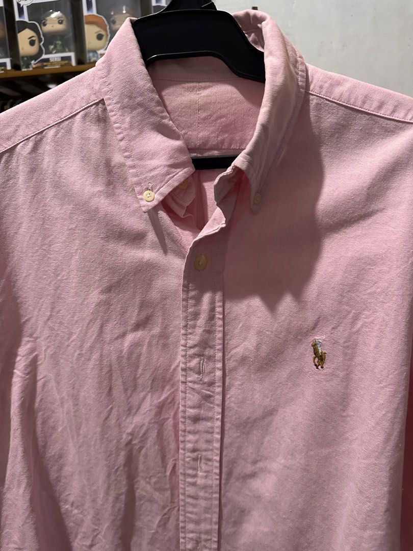 Pink Polo Ralph Lauren Button Down Shirt (Category: Tshirts & Polo Shirts ) located in Manila. Submitted by silverwolf.e5a5dc (Listing ID 1441515027, Image 2). Description: - Size 22x27 -Classic pink button-down shirt - Brand: Polo Ralph Lauren - Features signature embroidered pony logo on chest - Button-down collar - Long sleeves - Versatile for casual and smart-casual outfits - Easy to pair with jeans or chinos.