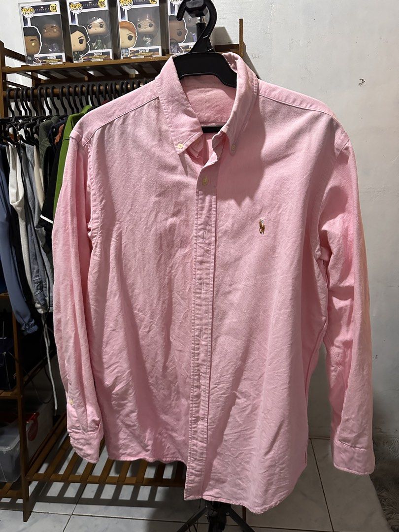 Pink Polo Ralph Lauren Button Down Shirt (Category: Tshirts & Polo Shirts ) located in Manila. Submitted by silverwolf.e5a5dc (Listing ID 1441515027, Image 1). Description: - Size 22x27 -Classic pink button-down shirt - Brand: Polo Ralph Lauren - Features signature embroidered pony logo on chest - Button-down collar - Long sleeves - Versatile for casual and smart-casual outfits - Easy to pair with jeans or chinos.