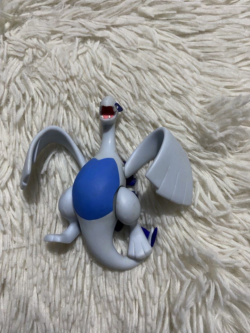 Pokemon Lugia Figure Toy (Category: Figurines & Statues) located in Bulacan. Submitted by rich2545 (Listing ID 1441576178, Image 3). Description: - Awesome Pokemon Lugia collectible figure - Striking white and blue color scheme - Dynamic pose with wings spread wide - Ideal for display shelves or playtime fun - Please note: No original box included.