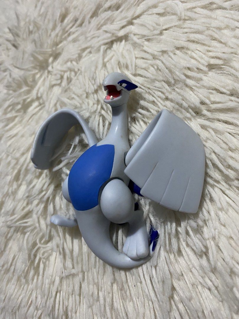 Pokemon Lugia Figure Toy (Category: Figurines & Statues) located in Bulacan. Submitted by rich2545 (Listing ID 1441576178, Image 1). Description: - Awesome Pokemon Lugia collectible figure - Striking white and blue color scheme - Dynamic pose with wings spread wide - Ideal for display shelves or playtime fun - Please note: No original box included.