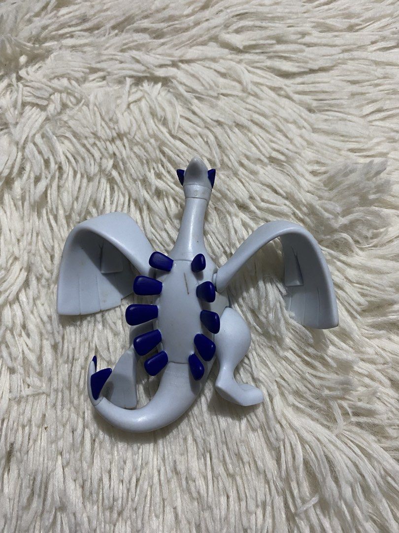 Pokemon Lugia Figure Toy (Category: Figurines & Statues) located in Bulacan. Submitted by rich2545 (Listing ID 1441576178, Image 2). Description: - Awesome Pokemon Lugia collectible figure - Striking white and blue color scheme - Dynamic pose with wings spread wide - Ideal for display shelves or playtime fun - Please note: No original box included.