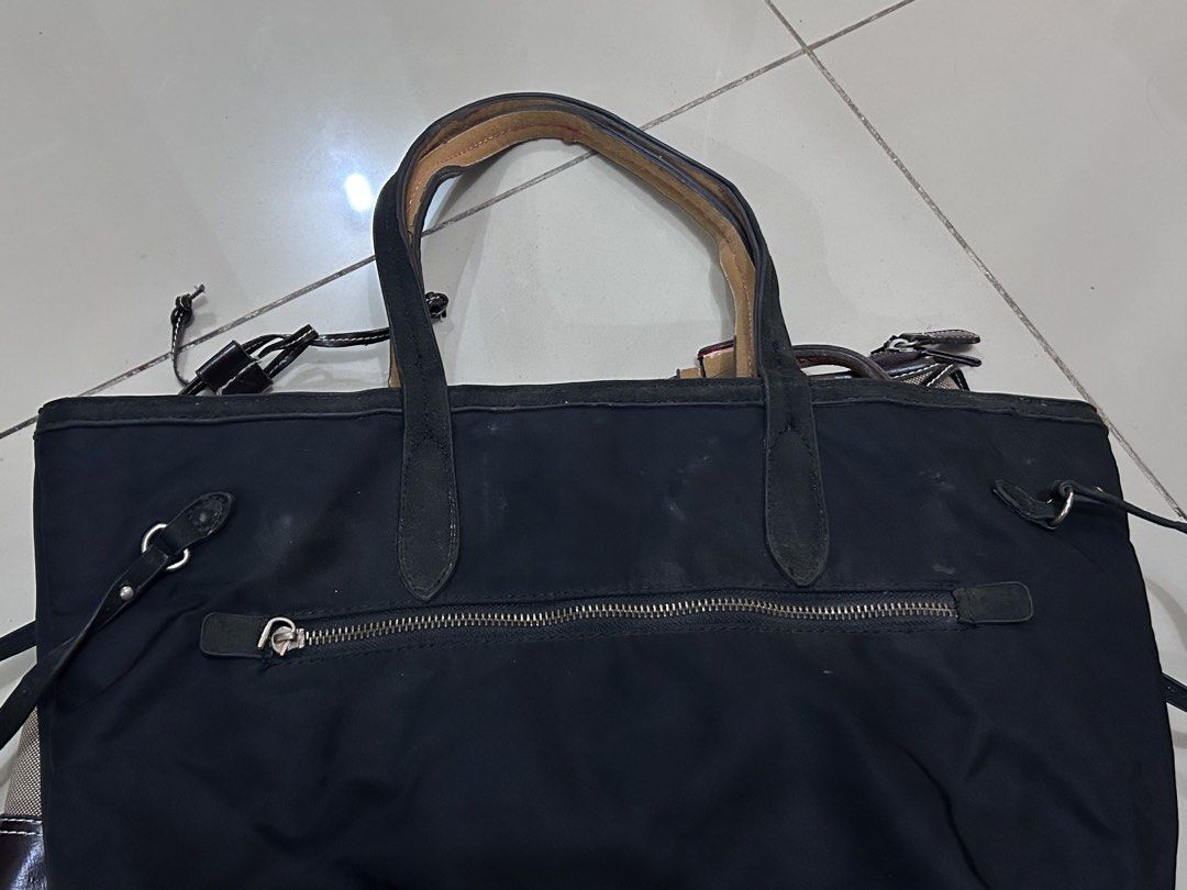 Prada Black Tessuto Tote Bag (Category: Luxury Bags & Wallets) located in Manila. Submitted by milkteeth (Listing ID 1441558542, Image 2). Description: • pre-loved & sold as is • interior zippers are functional and clean • body needs cleaning • negotiable issues: leather handles and interior trim are peeling and fraying + missing zipper - more image reference: https://www.jolicloset.com/en/designers-women/prada/womens-bags/totes/prada-black-tessu