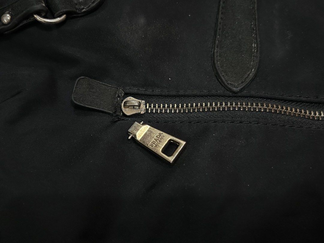 Prada Black Tessuto Tote Bag (Category: Luxury Bags & Wallets) located in Manila. Submitted by milkteeth (Listing ID 1441558542, Image 3). Description: • pre-loved & sold as is • interior zippers are functional and clean • body needs cleaning • negotiable issues: leather handles and interior trim are peeling and fraying + missing zipper - more image reference: https://www.jolicloset.com/en/designers-women/prada/womens-bags/totes/prada-black-tessu
