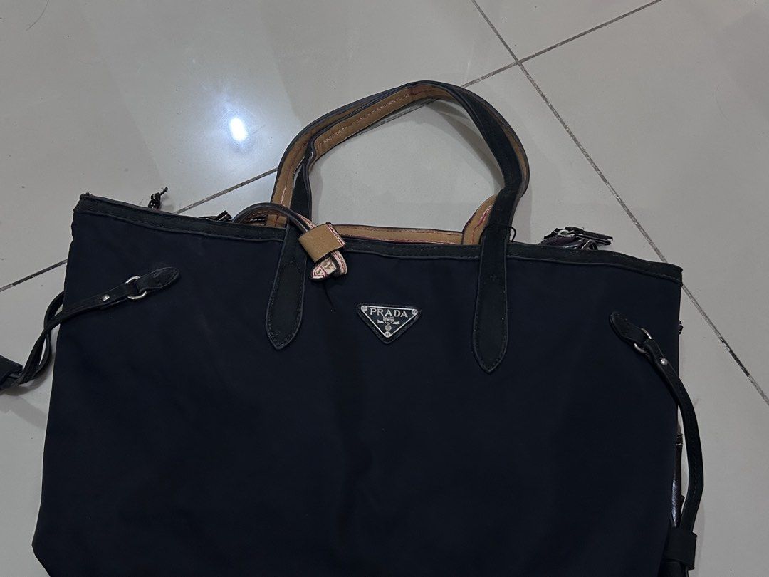 Prada Black Tessuto Tote Bag (Category: Luxury Bags & Wallets) located in Manila. Submitted by milkteeth (Listing ID 1441558542, Image 1). Description: • pre-loved & sold as is • interior zippers are functional and clean • body needs cleaning • negotiable issues: leather handles and interior trim are peeling and fraying + missing zipper - more image reference: https://www.jolicloset.com/en/designers-women/prada/womens-bags/totes/prada-black-tessu