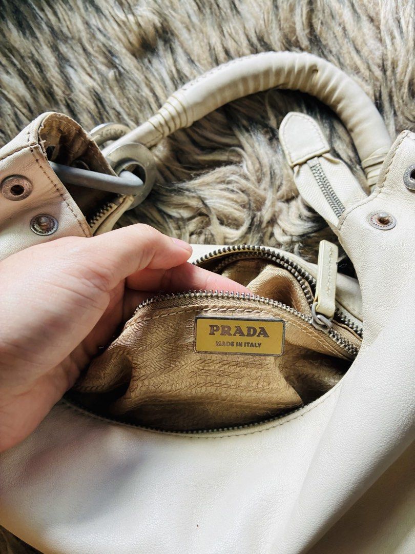 Prada White Leather Hobo Shoulder Bag (Category: Luxury Bags & Wallets) located in Makati City. Submitted by selltoshine (Listing ID 1441391365, Image 2). Description: - Vintage Prada hobo bag - Creamy white leather - Classic crescent shape - Silver hardware details - Interior zip pocket - Made in Italy - Great everyday bag.