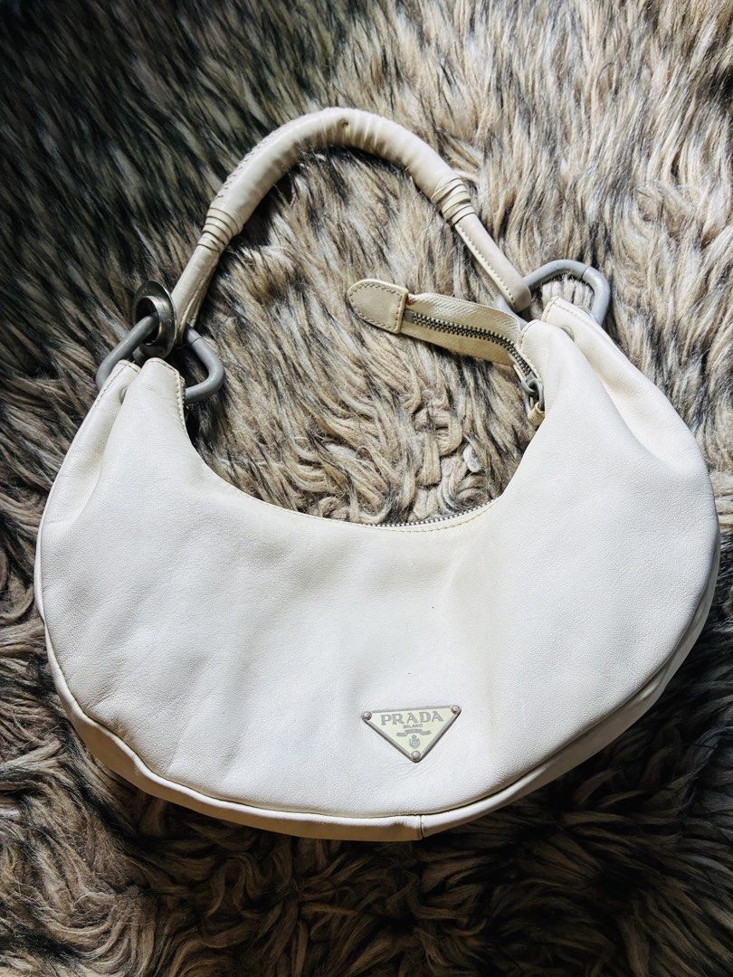 Prada White Leather Hobo Shoulder Bag (Category: Luxury Bags & Wallets) located in Makati City. Submitted by selltoshine (Listing ID 1441391365, Image 3). Description: - Vintage Prada hobo bag - Creamy white leather - Classic crescent shape - Silver hardware details - Interior zip pocket - Made in Italy - Great everyday bag.