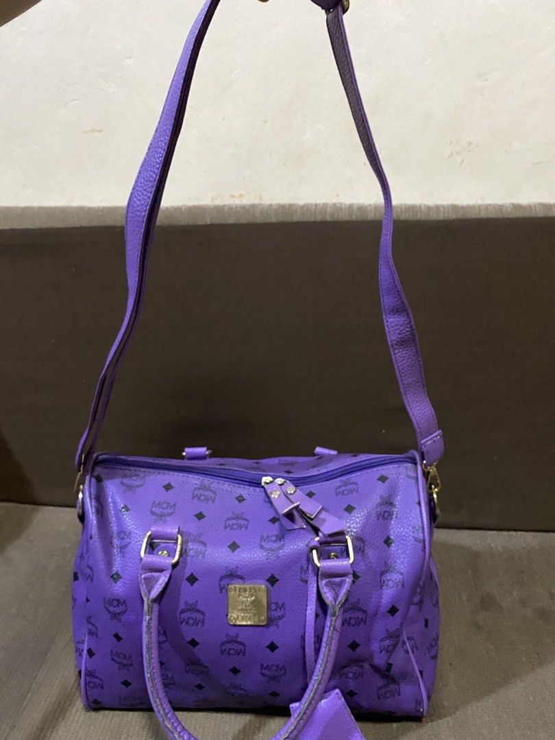 Purple MCM Monogram Boston Bag (Category: Luxury Bags & Wallets) located in San Antonio. Submitted by pixiechromzzz (Listing ID 1441516176, Image 3). Description: - purple MCM Boston bag - Signature monogram print - Gold-tone hardware and leather trim - Detachable shoulder strap included - Secure zipper closure - Ideal for everyday style and practicality - Approximate dimensions: 12"L x 6"W x 7"H.