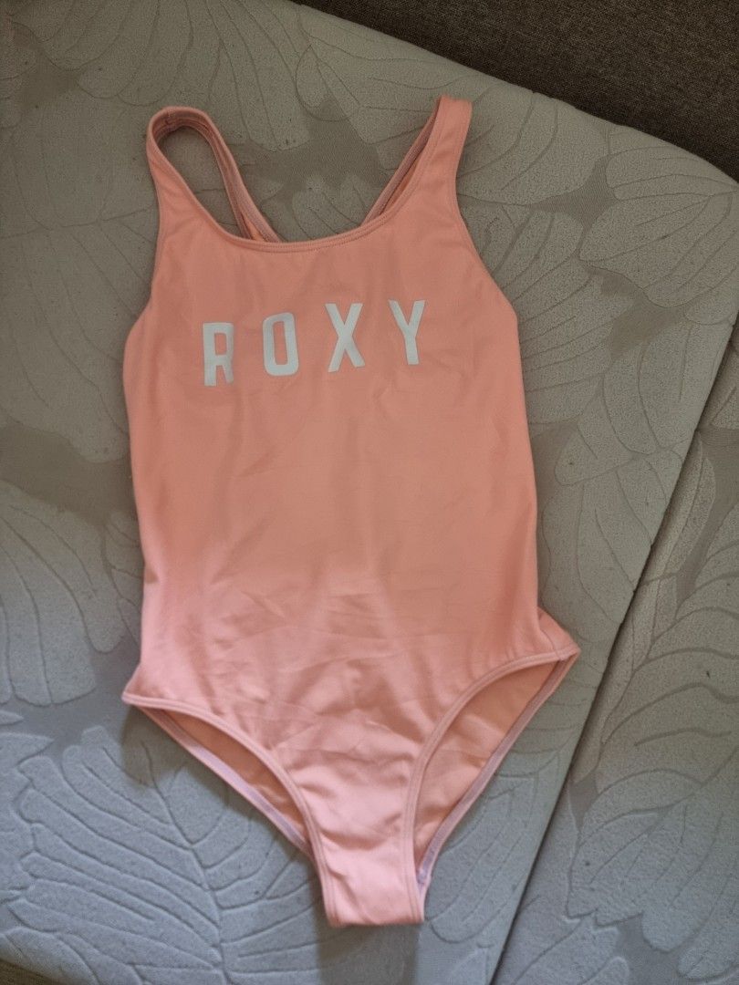 Roxy One-Piece Swimsuit Coral Size 10 (Category: Babies & Kids Fashion) located in Santa Rosa. Submitted by grace116 (Listing ID 1441412888, Image 1). Description: - Roxy one-piece swimsuit in coral pink - Features Roxy logo on the front - 'Since 1990' detail on the back - Cross-back straps for a secure and comfortable fit - Made in China - Ideal for swimming, beach days, or any water activity.