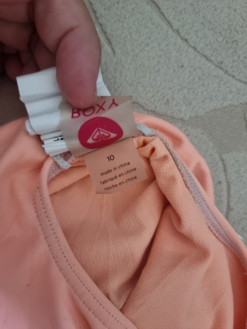 Roxy One-Piece Swimsuit Coral Size 10 (Category: Babies & Kids Fashion) located in Santa Rosa. Submitted by grace116 (Listing ID 1441412888, Image 3). Description: - Roxy one-piece swimsuit in coral pink - Features Roxy logo on the front - 'Since 1990' detail on the back - Cross-back straps for a secure and comfortable fit - Made in China - Ideal for swimming, beach days, or any water activity.