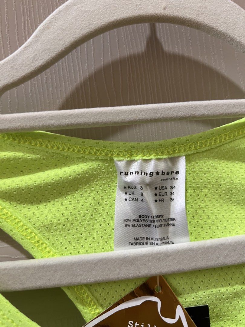 (RUNNING BARE) Neon Yellow Action Back Tank Top (Category: Activewear) located in Angono. Submitted by elyenitty_ (Listing ID 1441500263, Image 2). Description: - Neon yellow running tank top from Running Bare - Made in Australia - Breathable mesh fabric - Racerback design for freedom of movement - 'Running Bare' logo printed on the front - Lightweight and comfortable - Ideal for workouts or casual wear.