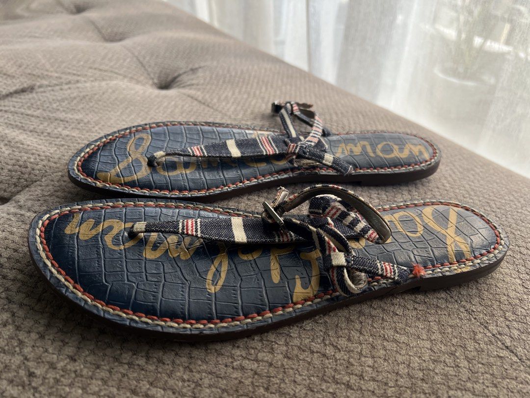 Sam Edelman Navy Striped Thong Sandals Size 9 (Category: Flats & Sandals) located in Makati City. Submitted by esila.essentials (Listing ID 1441574797, Image 2). Description: - Navy blue Sam Edelman sandals - Size 9 - T-strap design with red, white, and blue striped accents - Textured crocodile print footbed - Sam Edelman logo on soles - Ideal for casual wear.