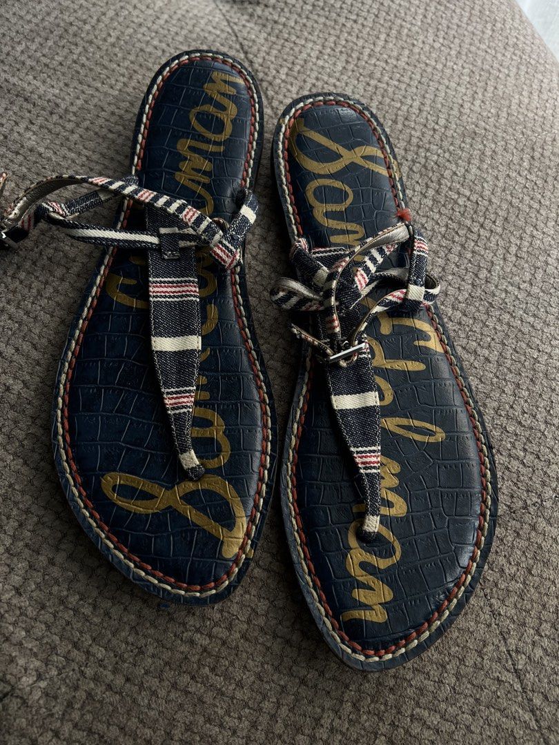 Sam Edelman Navy Striped Thong Sandals Size 9 (Category: Flats & Sandals) located in Makati City. Submitted by esila.essentials (Listing ID 1441574797, Image 3). Description: - Navy blue Sam Edelman sandals - Size 9 - T-strap design with red, white, and blue striped accents - Textured crocodile print footbed - Sam Edelman logo on soles - Ideal for casual wear.