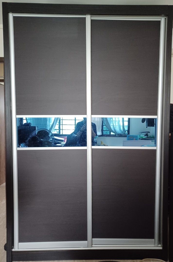 Sliding Door Wardrobe with Mirror Panel (Category: Shelves, Cabinets & Racks) located in Singapore. Submitted by j_heaven (Listing ID 1441511031, Image 1). Description: - 152 (L) x 240 (H) x 60 (D) - $50 (1 wardrobe) or $80 (2 wardrobes) - 2 x Dark brown sliding door wardrobe - 2nd Wardrobe both left & right side is the same in photo 2 - Horizontal mirror panel in the middle - Dark wood frame with silver aluminum trim. Made of durable plywood. - 