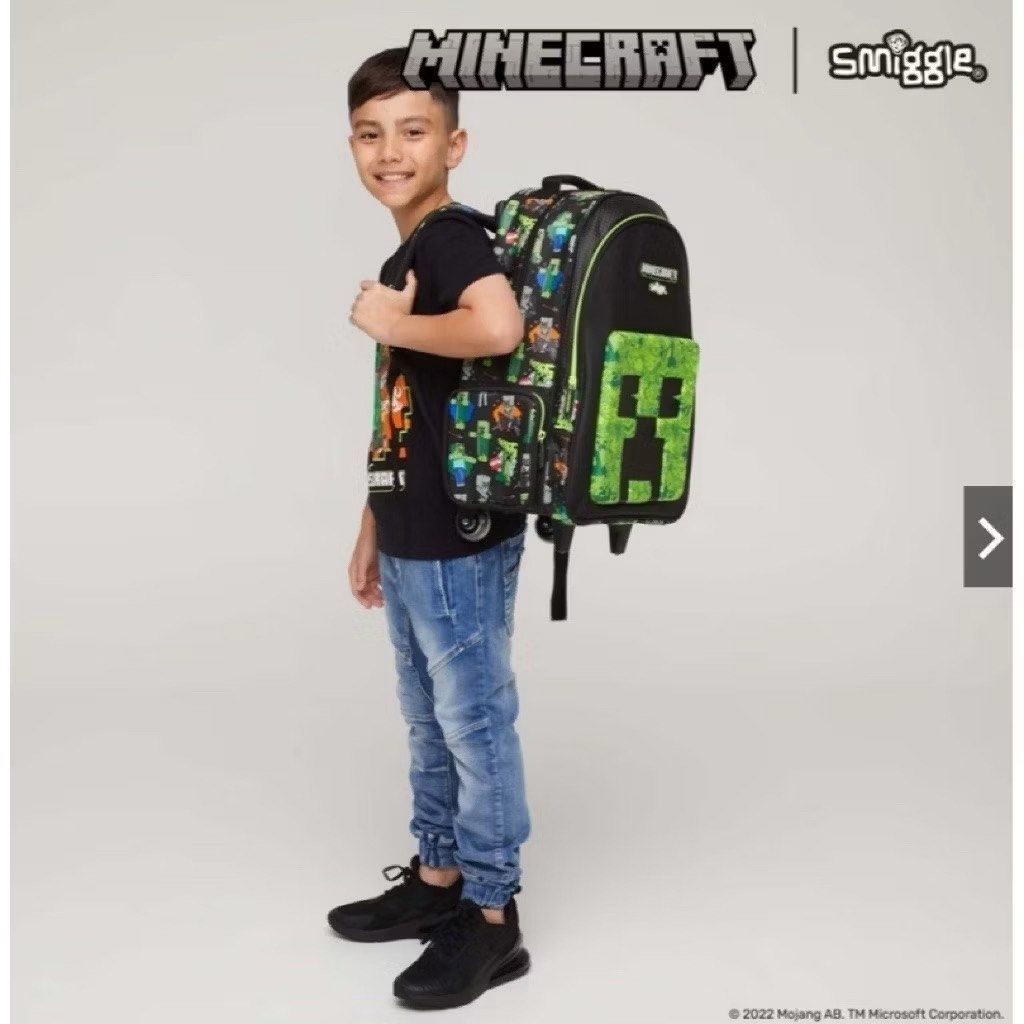 Smiggle Minecraft Rolling Backpack with Wheels (Category: Babies & Kids Fashion) located in Calamba. Submitted by hgrajo (Listing ID 1441494133, Image 2). Description: - Official Smiggle x Minecraft collaboration - Features iconic Creeper face on the front - Fun Minecraft character prints on straps and sides - Built-in wheels for easy rolling - Retractable handle for convenient transport - Ideal for school, travel, or everyday use - Kids will lov