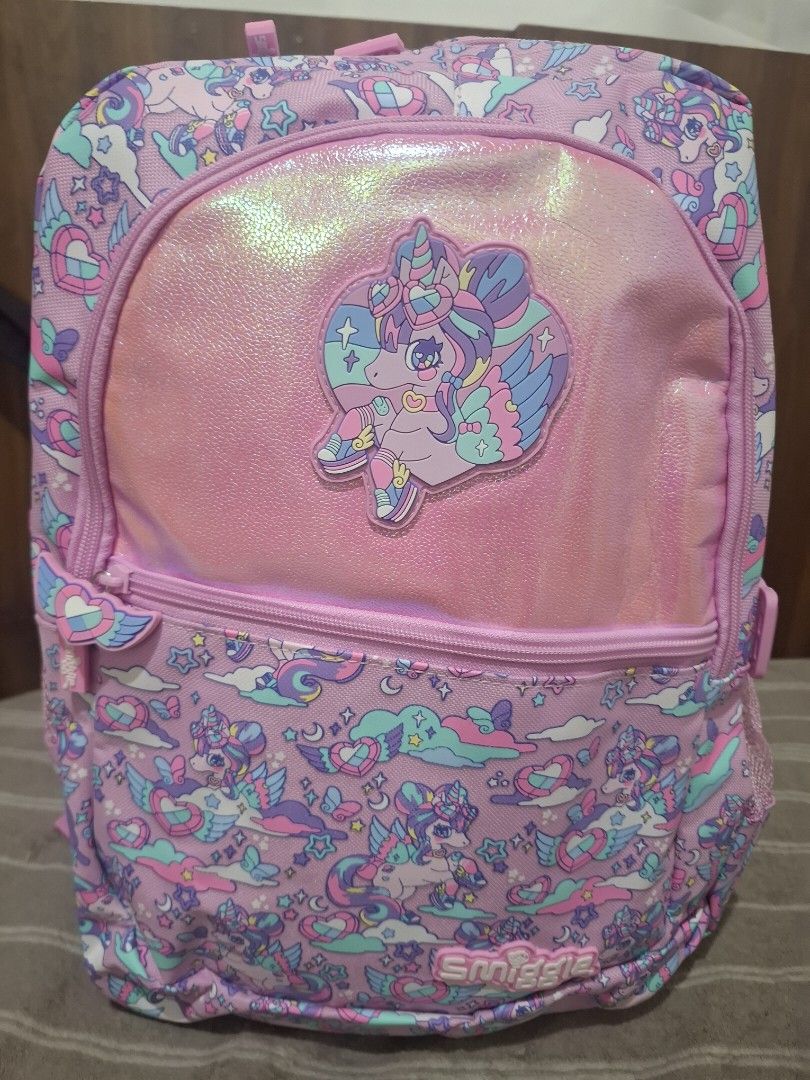 Smiggle Unicorn Backpack Pink Purple Blue (Category: Backpacks) located in Manila. Submitted by brekkas.ph (Listing ID 1441581415, Image 1). Description: - Adorable pink backpack with a fun unicorn and star print. - Features comfortable padded straps. - Includes a convenient mesh side pocket. - Sparkly front panel with a cute unicorn patch. - All zippers are smooth and easy to use. - Ideal for school, day trips, or everyday adventures..