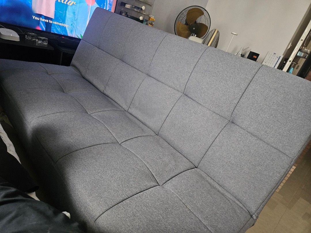 Sofa Bed (Category: Sofas) located in Singapore. Submitted by reddatesdrink (Listing ID 1441513228, Image 1). Description: - Grey tufted sofa bed - Folds out flat for easy conversion - Ideal for small spaces - Durable fabric upholstery - Sturdy wooden legs - Easy to clean material - Perfect for guests or everyday lounging.