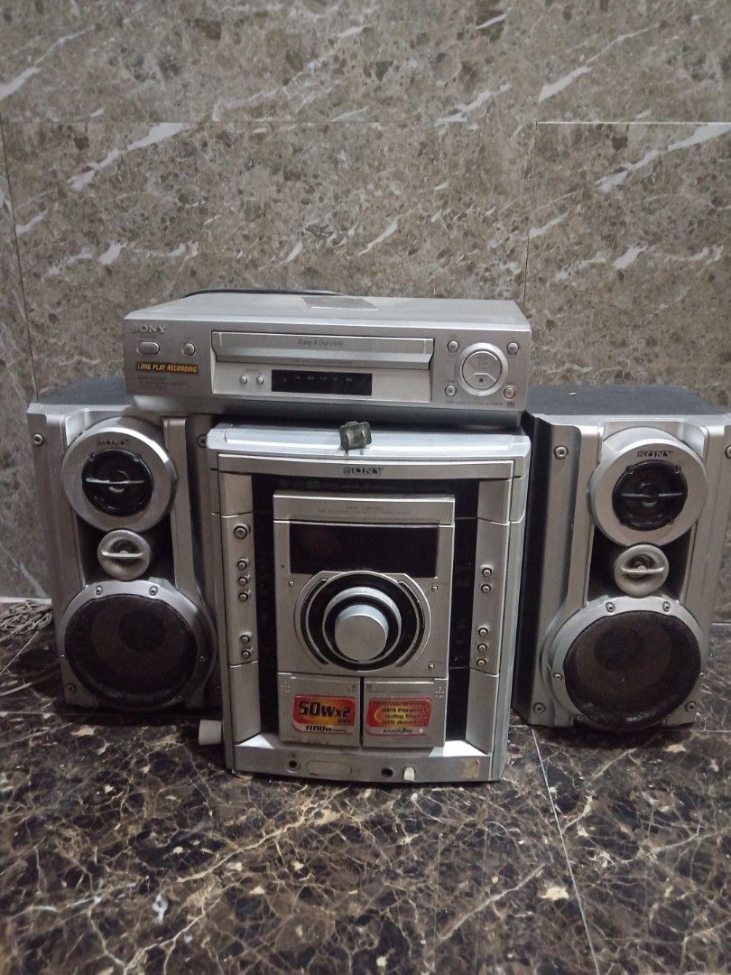 Sony Home Stereo System with CD Player and Speakers (Category: Soundbars, Speakers & Amplifiers) located in Manila. Submitted by jibrilaskr77691 (Listing ID 1441549272, Image 1). Description: - Sony Home Stereo System - Includes: Main unit, CD player, 2 speakers - Main unit features large volume dial and display screen - Speakers: Silver with black grilles - Delivers great sound quality.