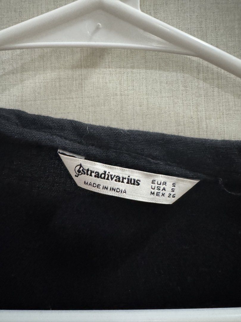 Stradivarius Black Button-Up Midi Dress Size S (Category: Dresses) located in Quezon City. Submitted by kcapi (Listing ID 1441531217, Image 2). Description: - Brand: Stradivarius - Type: Black Midi Dress - Size: S - Sleeves: Short sleeves - Neckline: V-neck - Closure: Button-up front with white buttons - Hem: Tiered detail - Origin: Made in India.