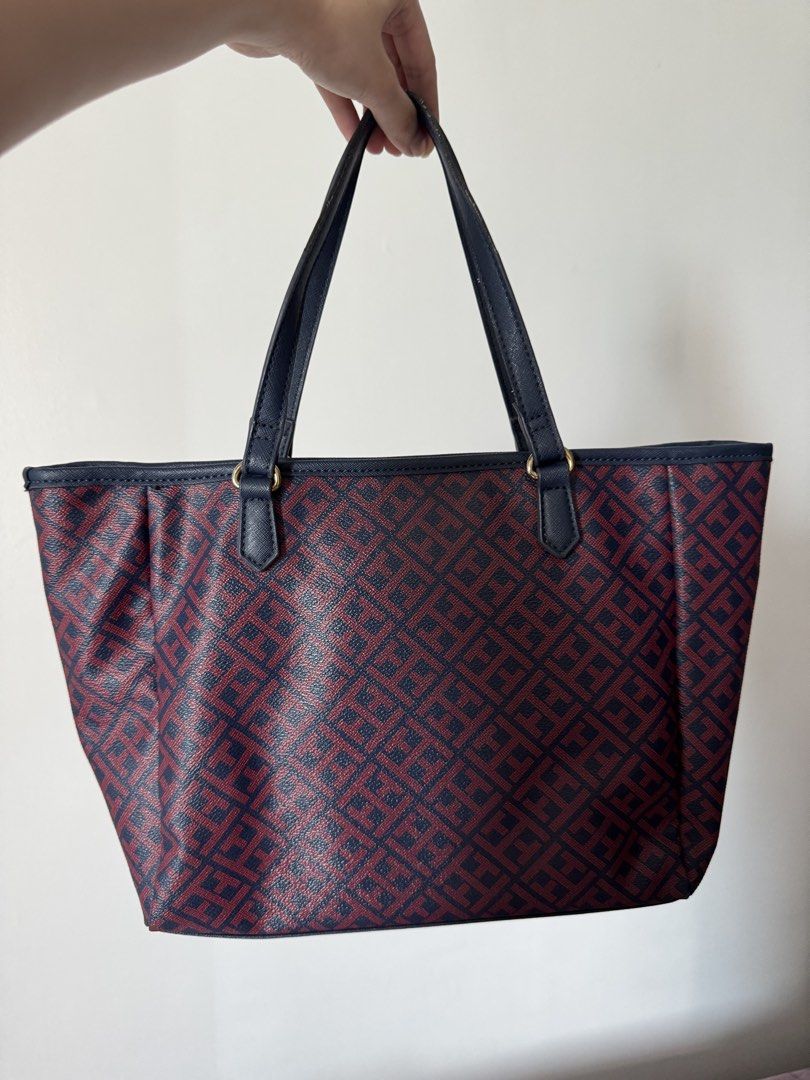 Tommy Hilfiger Monogram Tote Bag (Category: Tote Bags) located in Quezon City. Submitted by nbg.declutter (Listing ID 1441380175, Image 3). Description: - Classic Tommy Hilfiger tote bag - Signature navy and burgundy monogram pattern - Convenient front pocket for easy access - Sturdy top handles for comfortable carrying - Ideal for everyday use -Strap just needs rubber replacement.