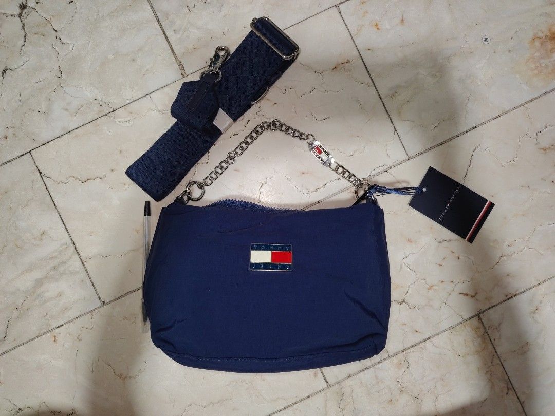 Tommy Hilfiger Navy Blue Shoulder Bag with Strap (Category: Shoulder Bags) located in Cainta. Submitted by badet0521 (Listing ID 1441555720, Image 3). Description: - Navy blue Tommy Hilfiger shoulder bag - Detachable strap included - Chain handle for versatile carrying - Classic Tommy Hilfiger logo on the front - Spacious interior for essentials - Ideal for everyday use or evening outings.