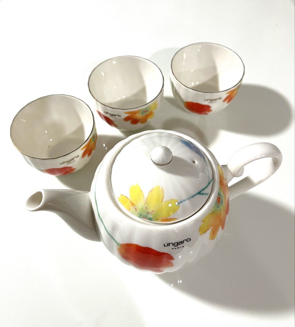 Ungaro Maebata Japan Floral Tea Set (Category: Coffee & Tea Tableware) located in Pasig City. Submitted by tylernchloe (Listing ID 1441383339, Image 1). Description: - Beautiful Ungaro Paris Maebata Japan teapot and 3 teacups - Lovely summer floral design with red, yellow, and blue flowers - Features a ribbed texture on teapot and cups.