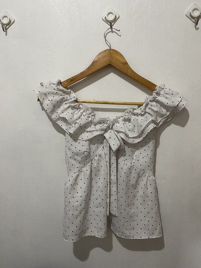 White Polka Dot Off-Shoulder Ruffle Tie Front Top (Category: Blouses) located in Manila. Submitted by carmelana (Listing ID 1441517689, Image 3). Description: - Cute white top with black polka dots - Off-shoulder design with ruffles - Tie front detail - Versatile: pairs well with jeans or skirts - fits small to medium.