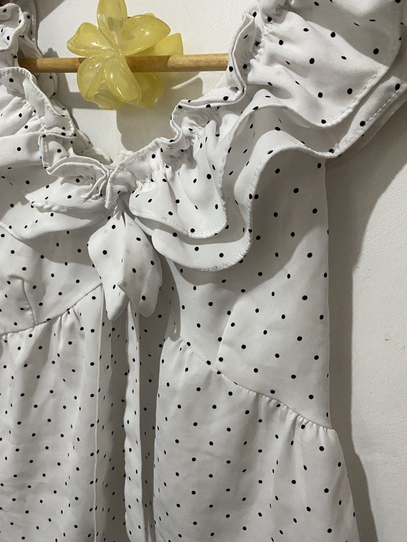 White Polka Dot Off-Shoulder Ruffle Tie Front Top (Category: Blouses) located in Manila. Submitted by carmelana (Listing ID 1441517689, Image 2). Description: - Cute white top with black polka dots - Off-shoulder design with ruffles - Tie front detail - Versatile: pairs well with jeans or skirts - fits small to medium.