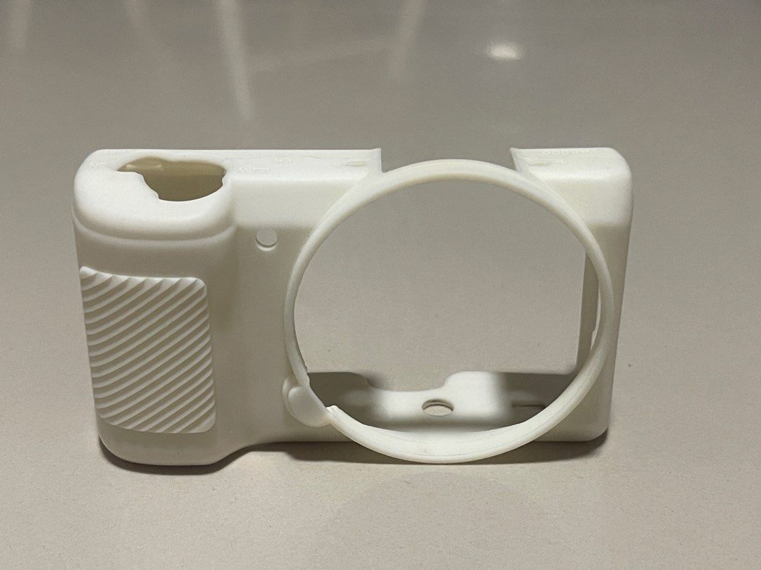 White Silicone Camera Case (Sony a5100, a5000) with Dark Grey Camera Strap (Category: Camera Bags & Carriers) located in San Jose del Monte. Submitted by adrian.tzn (Listing ID 1441545666, Image 3). Description: - White silicone camera case for protection. - Dark grey adjustable and comfortable camera strap. - Ideal for protecting your camera while traveling. - Can be sold seperately: - P150 Camera Silicone Case - P120 Camera strap.
