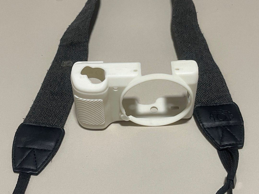 White Silicone Camera Case (Sony a5100, a5000) with Dark Grey Camera Strap (Category: Camera Bags & Carriers) located in San Jose del Monte. Submitted by adrian.tzn (Listing ID 1441545666, Image 1). Description: - White silicone camera case for protection. - Dark grey adjustable and comfortable camera strap. - Ideal for protecting your camera while traveling. - Can be sold seperately: - P150 Camera Silicone Case - P120 Camera strap.