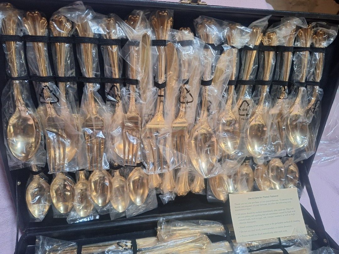William Rogers and Son Goldplated Flatware Set 62 Piece (Category: Dinnerware & Cutlery) located in Baguio. Submitted by be_blessed_boutique (Listing ID 1441512786, Image 2). Description: - Complete 62-piece gold-plated flatware set - Brand: William Rogers And Son - Pattern: Enchanted - All pieces individually wrapped in plastic - Includes a black storage case - Ideal for formal dining and special occasions - Full set for 8 people.