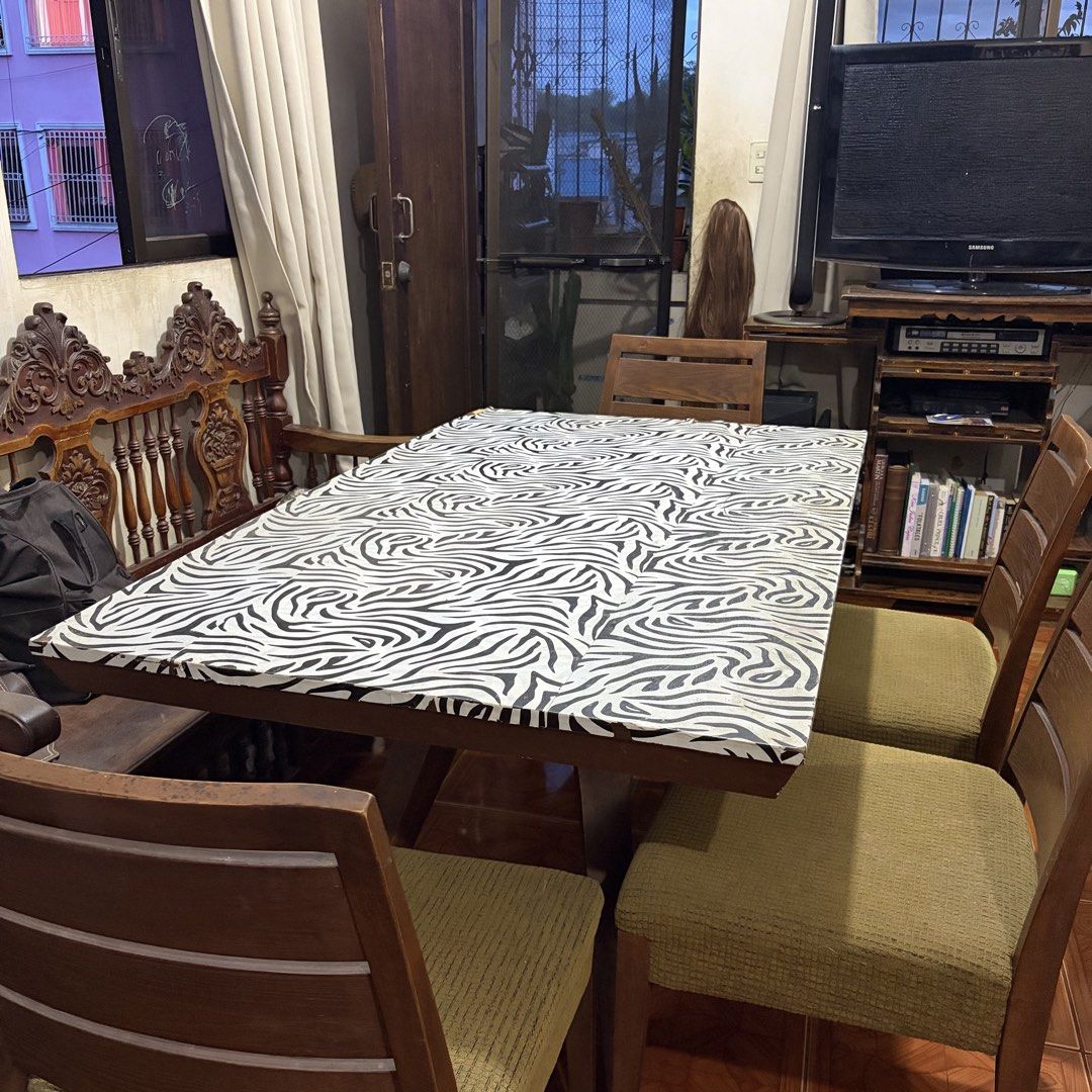 Wooden Dining Table w/ Foamed Chair (Category: Tables & Sets) located in Rizal. Submitted by _poknat (Listing ID 1441494010, Image 1). Description: Wooden dining table with removable zebra print sticker, with 6 wooden chairs (olive green seat foams) Flaws: Seen in pictures, chips in wood as well as stains in foam chairs..