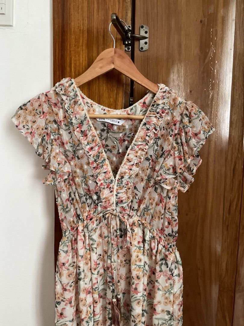 Zara Floral Ruffle Maxi Dress (Category: Dresses) located in Iloilo. Submitted by maecha (Listing ID 1441380562, Image 2). Description: - Flowy maxi dress - Delicate floral print - Flutter sleeves - Ruffled V-neckline - Elasticated waist with drawstring tie - Tiered hem for added movement - Perfect for casual outings or summer events.