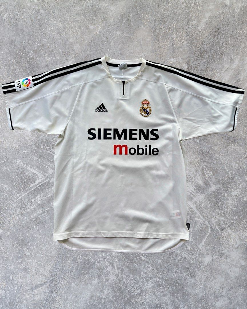 2003/04 Real Madrid ‘Asian Tour’ Home Shirt - #23 BECKHAM /football jersey/ kit rare/ retro/ vintage (Category: Activewear) located in Singapore. Submitted by jskitcult (Listing ID 1444911793, Image 2). Description: Product Size: M PTP: 56cm Length: 71cm Condition: Excellent Brand: Adidas Defects: Partial wear on the sponsor logo. Features: Features a rare and special Chinese Nameset of Beckham that was produced for the real madrid asian tour. Th