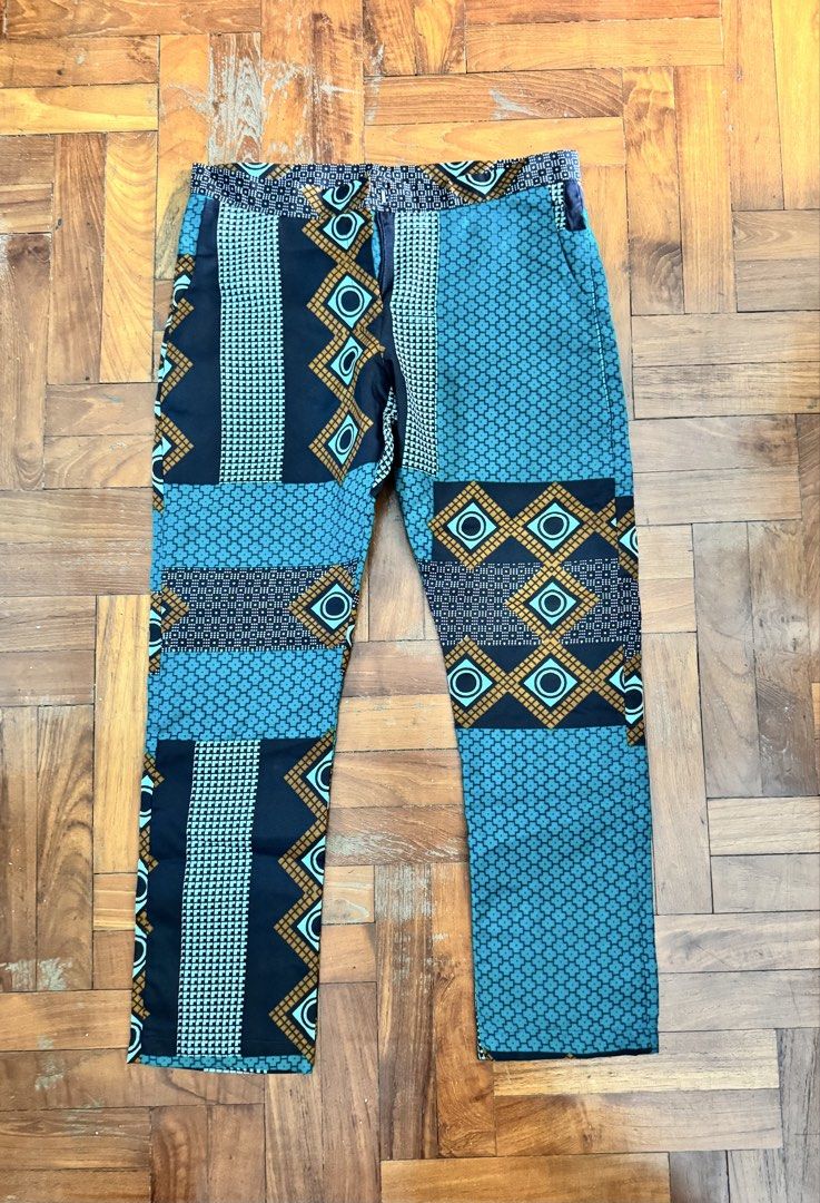 African Patchwork Pattern Pants (Category: Other Bottoms) located in Singapore. Submitted by okaykaya (Listing ID 1444951360, Image 1). Description: - Eye-catching patchwork design - Teal, black, and gold color palette - Comfortable elastic waistband - Classic straight leg fit - Makes a unique fashion statement - Ideal for casual wear.