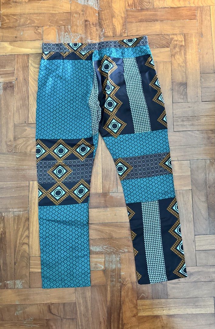 African Patchwork Pattern Pants (Category: Other Bottoms) located in Singapore. Submitted by okaykaya (Listing ID 1444951360, Image 2). Description: - Eye-catching patchwork design - Teal, black, and gold color palette - Comfortable elastic waistband - Classic straight leg fit - Makes a unique fashion statement - Ideal for casual wear.