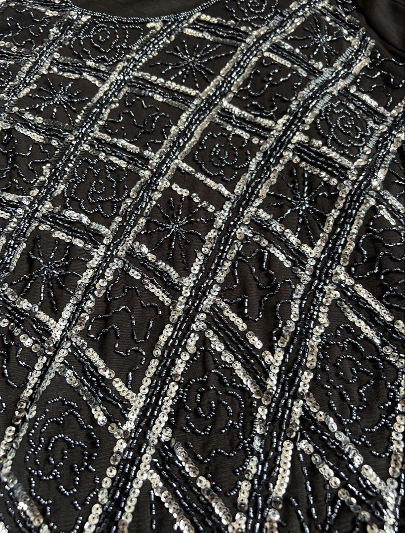Ansel Classic Black Beaded Long Sleeve Top (Category: Longsleeves) located in Santa Ana. Submitted by 999h03 (Listing ID 1444872433, Image 3). Description: - Black long sleeve top -xs-m - Intricate silver and blue beadwork on front (diamond pattern with floral accents) - Sheer mesh sleeves - Slightly curved hemline - Ideal for night outs or special occasions.
