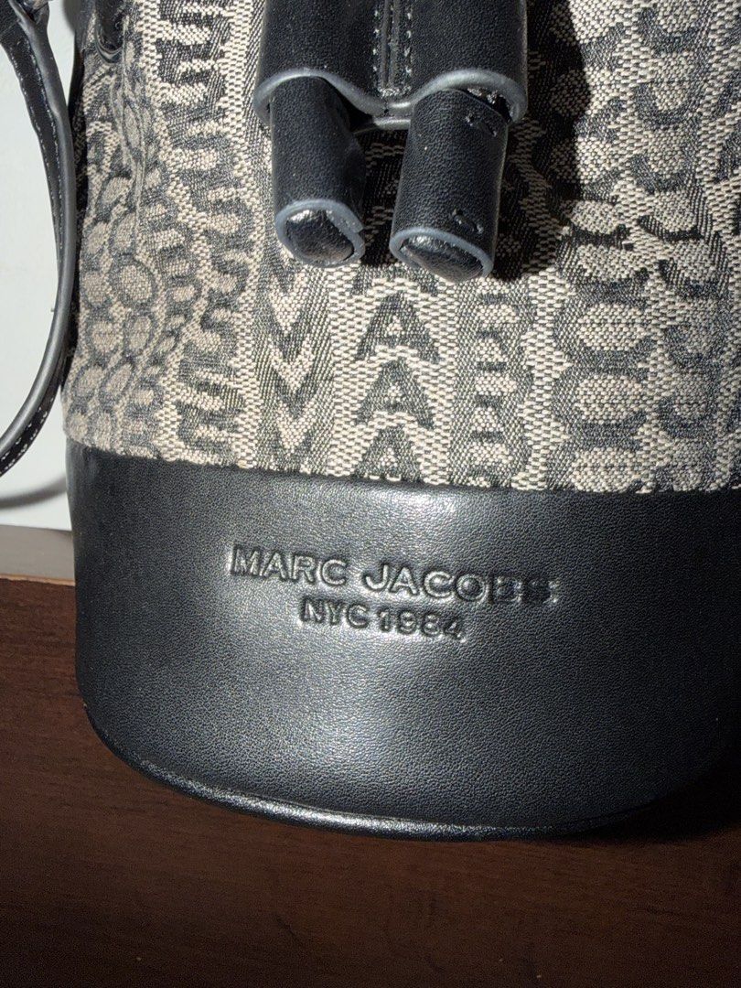 Authentic Marc Jacobs Mini Monogram Crossbody Bucket Bag (Category: Luxury Bags & Wallets) located in Cebu City. Submitted by shopnsave2015 (Listing ID 1445024649, Image 2). Description: With dustbag No flaws Missing sling In excellent condition Introducing the Marc Jacobs Mini Monogram Crossbody Bucket Bag, a perfect blend of sophistication and functionality. This exquisite accessory features a visually striking monogram design that enhances its