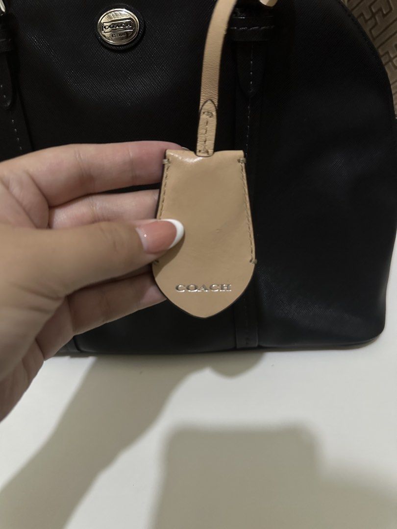Black Coach Peyton Cora Domed Satchel (Category: Luxury Bags & Wallets) located in Las Pinas. Submitted by bagsbyshai (Listing ID 1444915700, Image 3). Description: black Coach Peyton Cora Domed Satchel made of Saffiano leather featuring a contrasting cream leather luggage tag.